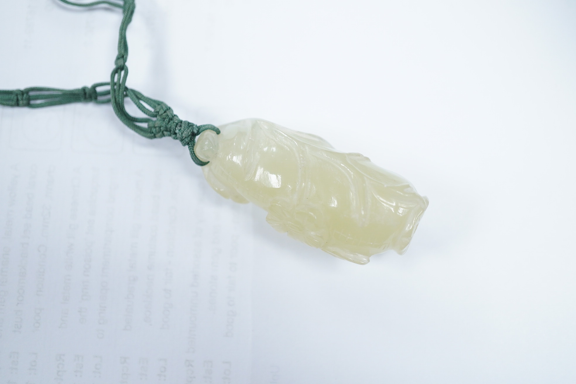 A Chinese bowenite jade pendant and bead necklace. Condition - fair to good